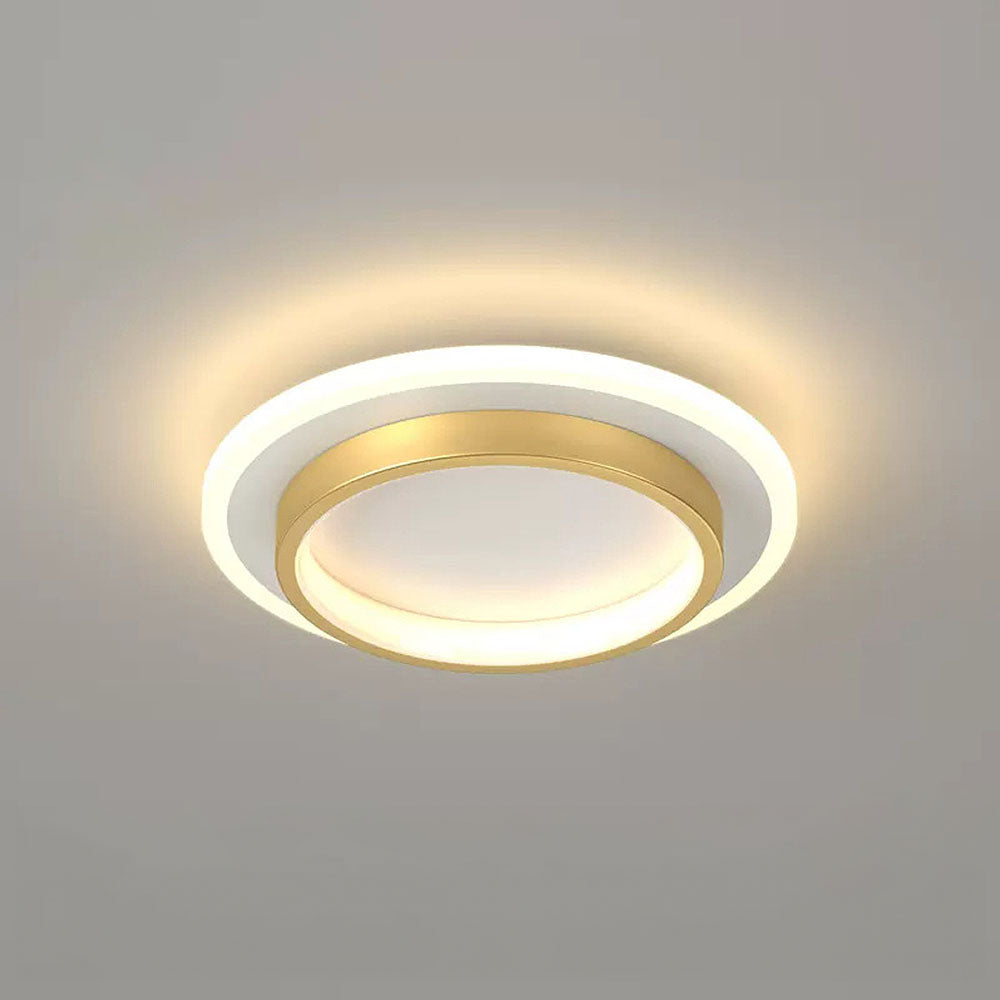 Close-up of a modern gold geometric LED flush mount mura ceiling light glowing