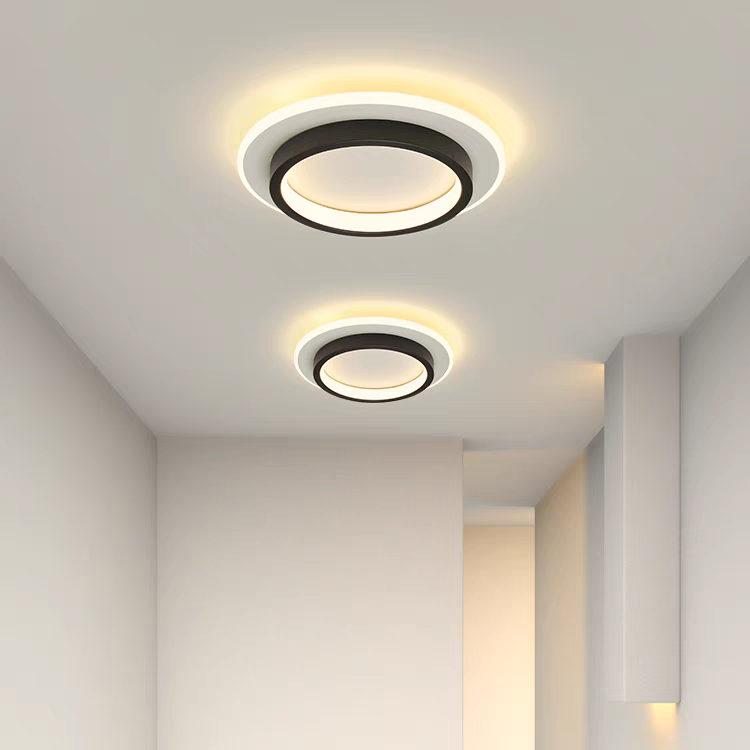 Pair of black geometric LED mura ceiling lamps providing even illumination in a minimalist interior