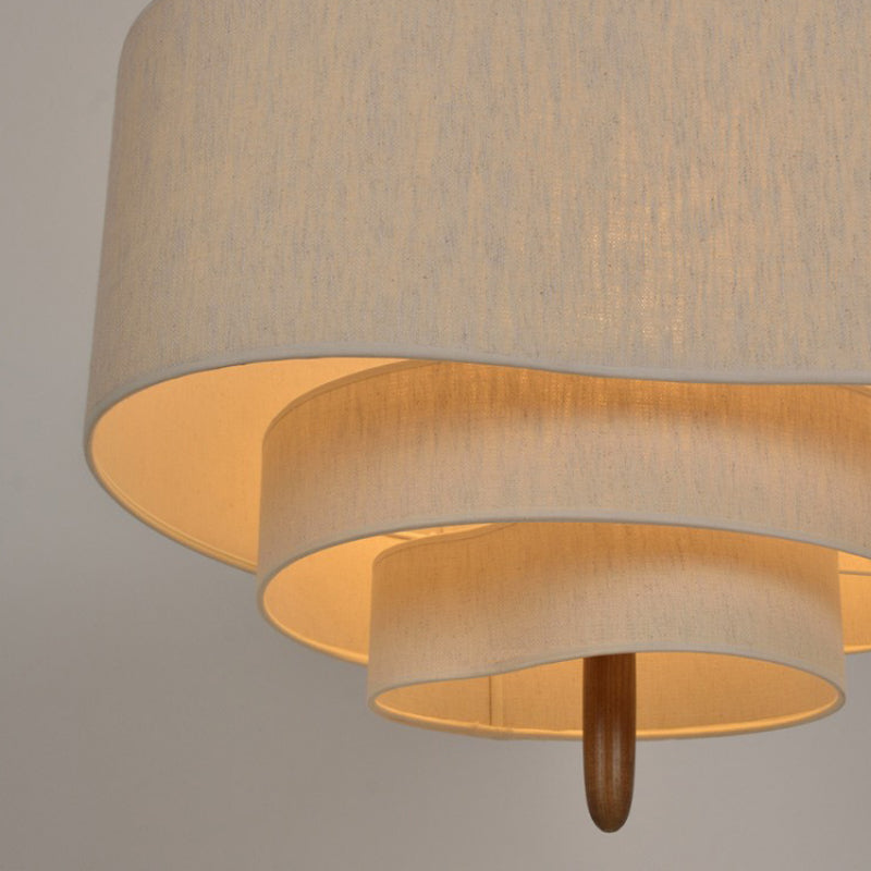 Underside view of the myska tiered linen pendant light showcasing its layered light diffusion and wooden pillar accent