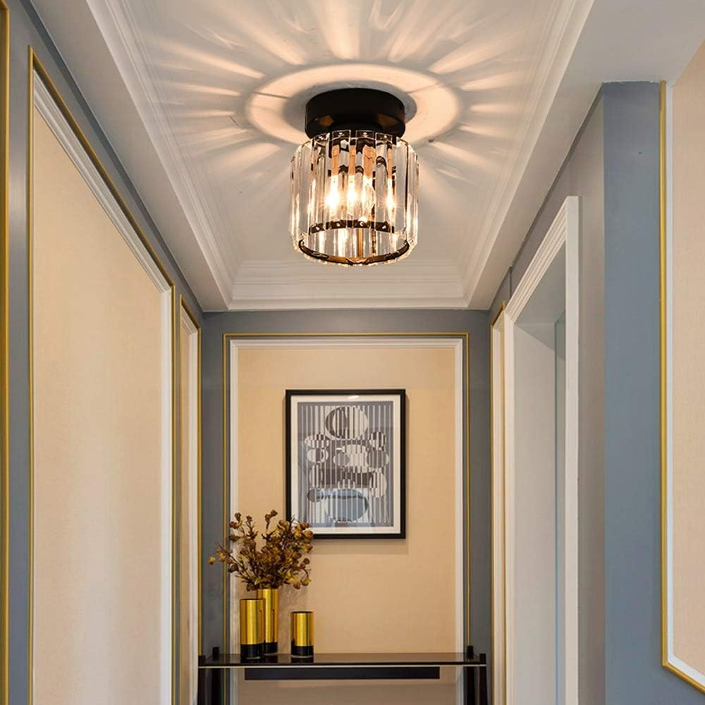 Black round crystal netyf ceiling light providing ambient starburst illumination in a dark corridor