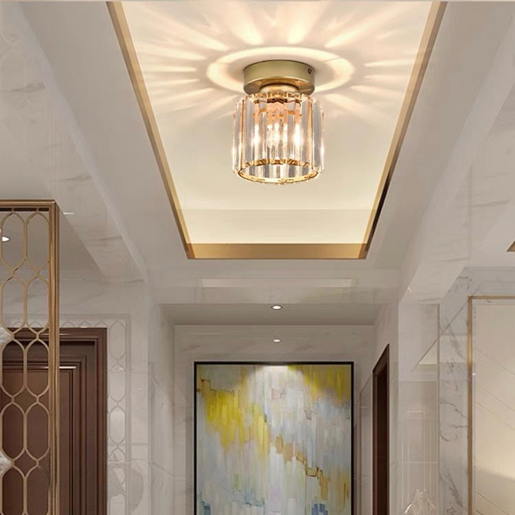 Gold round crystal mini netyf chandelier casting a warm starburst pattern in a corridor