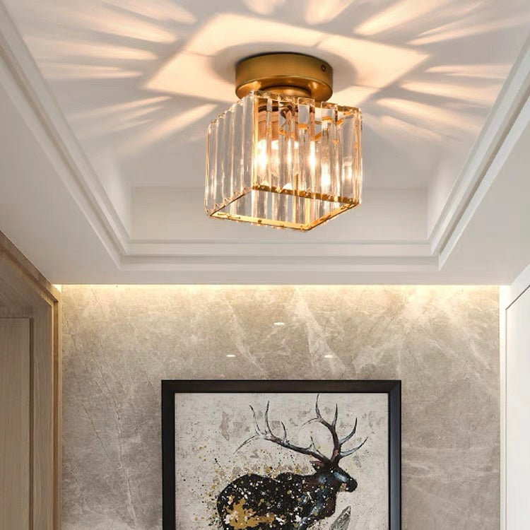 Gold square crystal prism flush mount netyf light illuminating a luxurious marble hallway