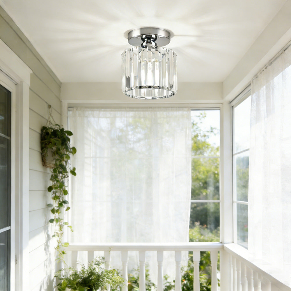 Modern silver round crystal flush mount netyf fixture in a bright, sunlit entryway