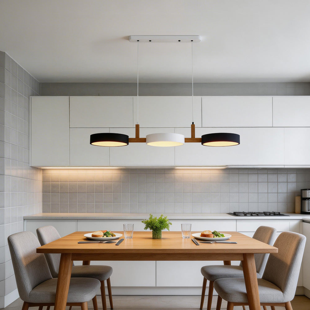 Black, white, and black linear nohit pendant contrasting beautifully over a wooden dining table