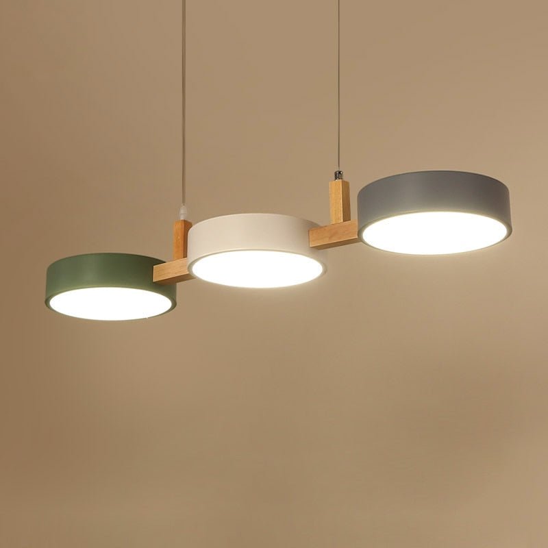 Solid 3 light Nordic nohit linear chandelier hanging against a warm, neutral background