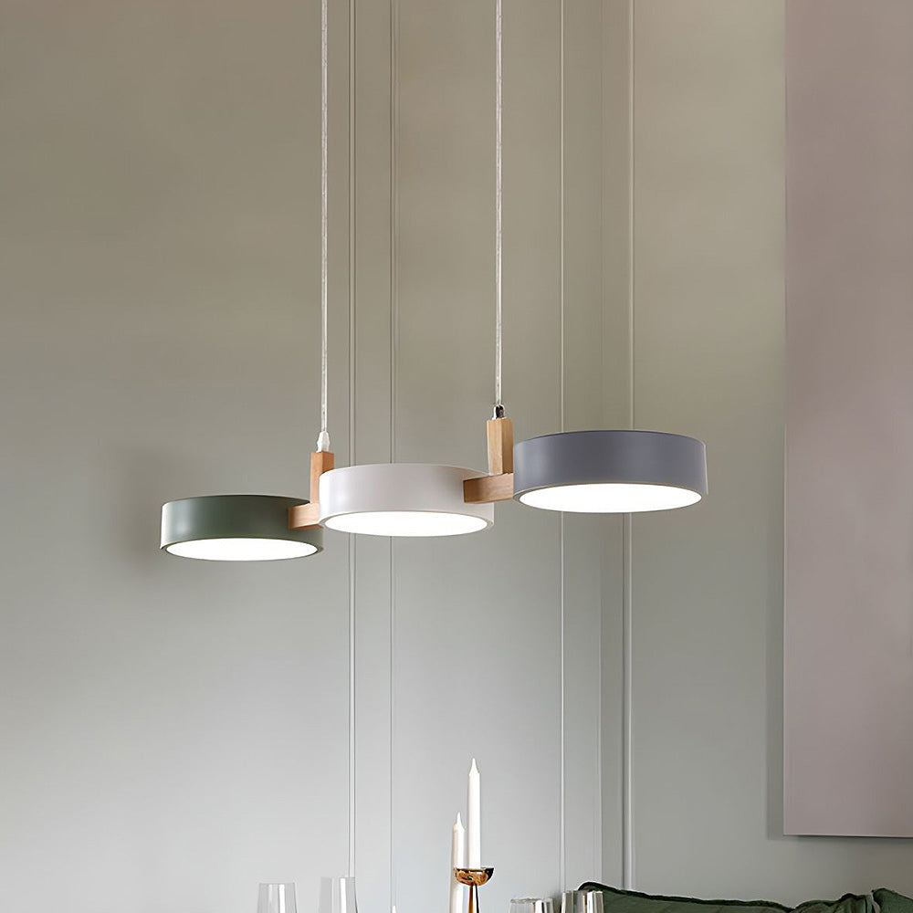 Solid nohit 3-light linear pendant lamp suspended in a modern kitchen.