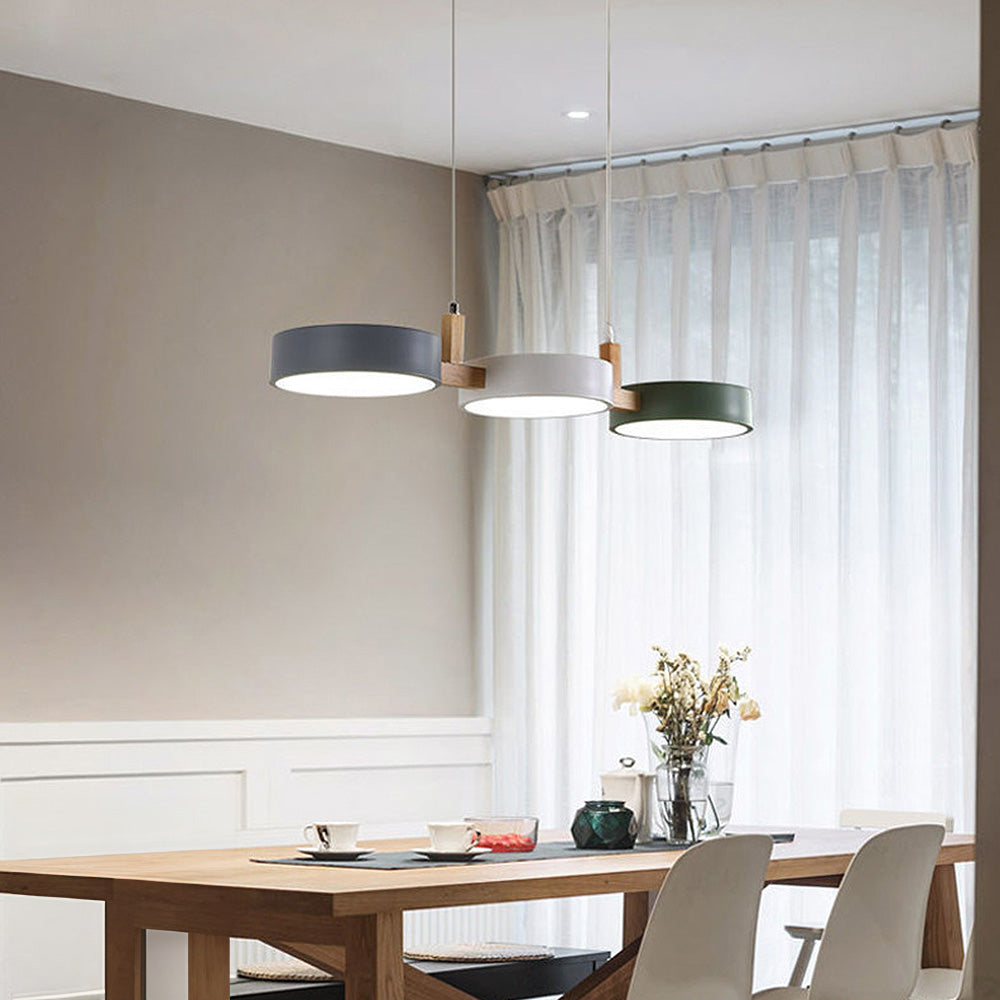 Three-head drum nohit chandelier acting as an elegant focal point in a dining space