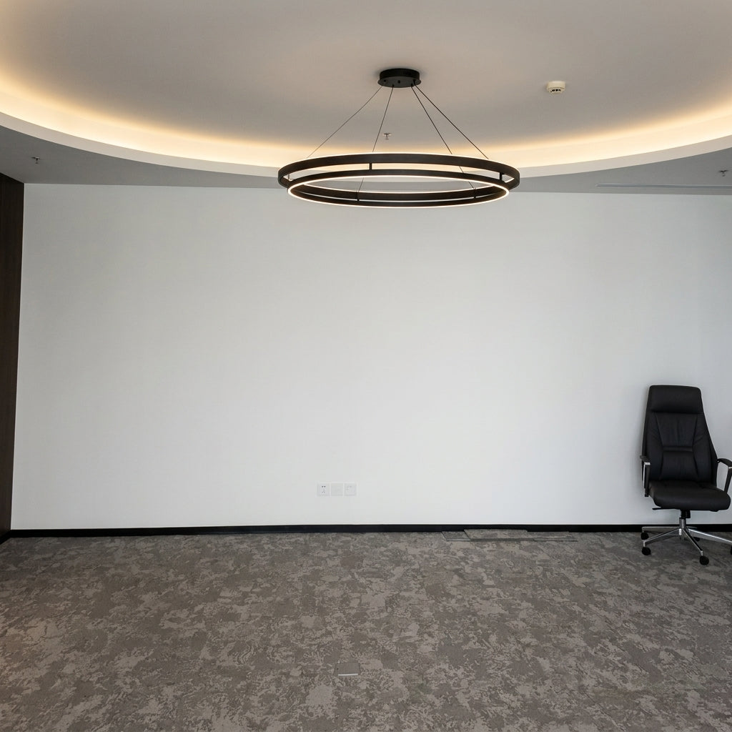 Wide view of the Nyles two-ring LED chandelier on a ceiling with coving in a plain white room