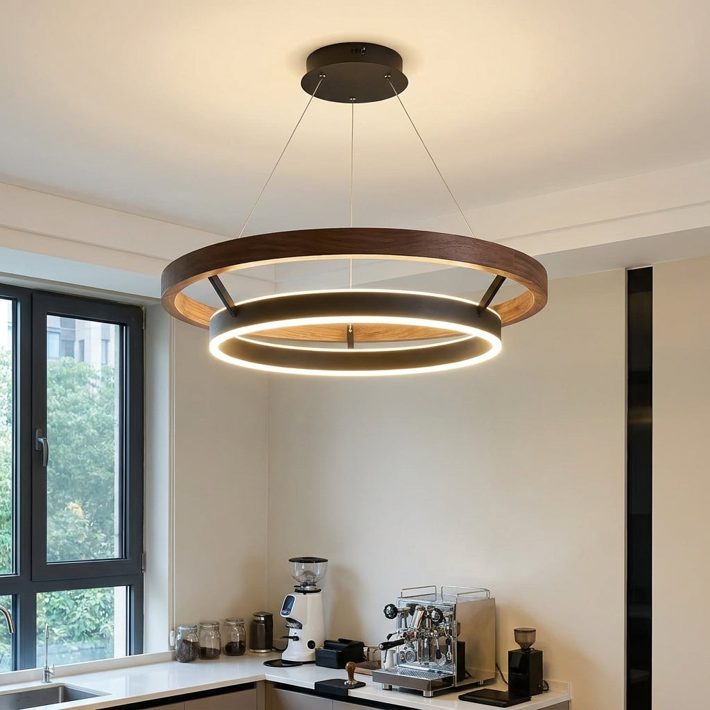 Nyles two-ring wood-grain LED chandelier in a white room beside a window