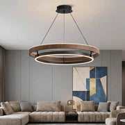 Nyles wood-grain two-ring LED chandelier hanging above a taupe sectional sofa in a living room with abstract wall art