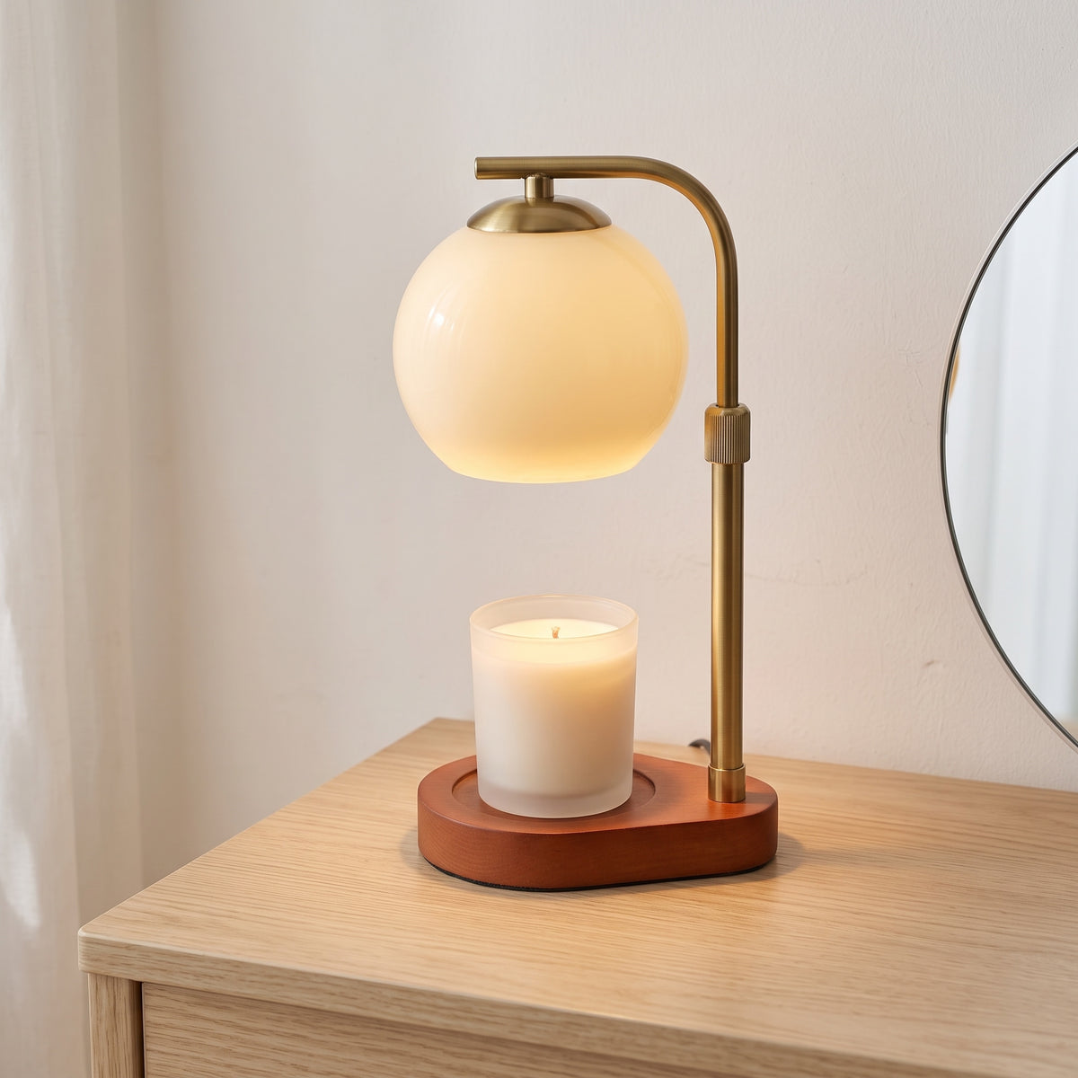 Orsa glass globe candle warmer lamp warming a white candle jar on an oak dressing table