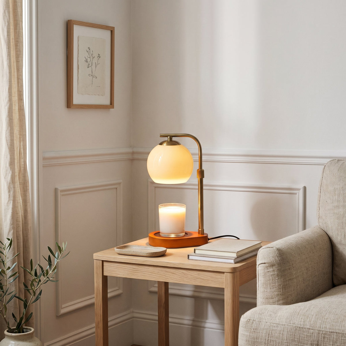 Orsa glass globe candle warmer lamp on an oak side table in a living room corner
