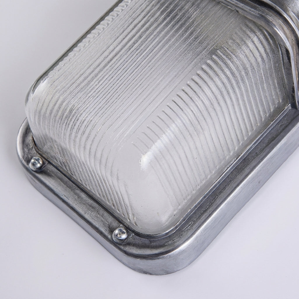Close-up of the Ostin ribbed glass diffuser and aluminium surround