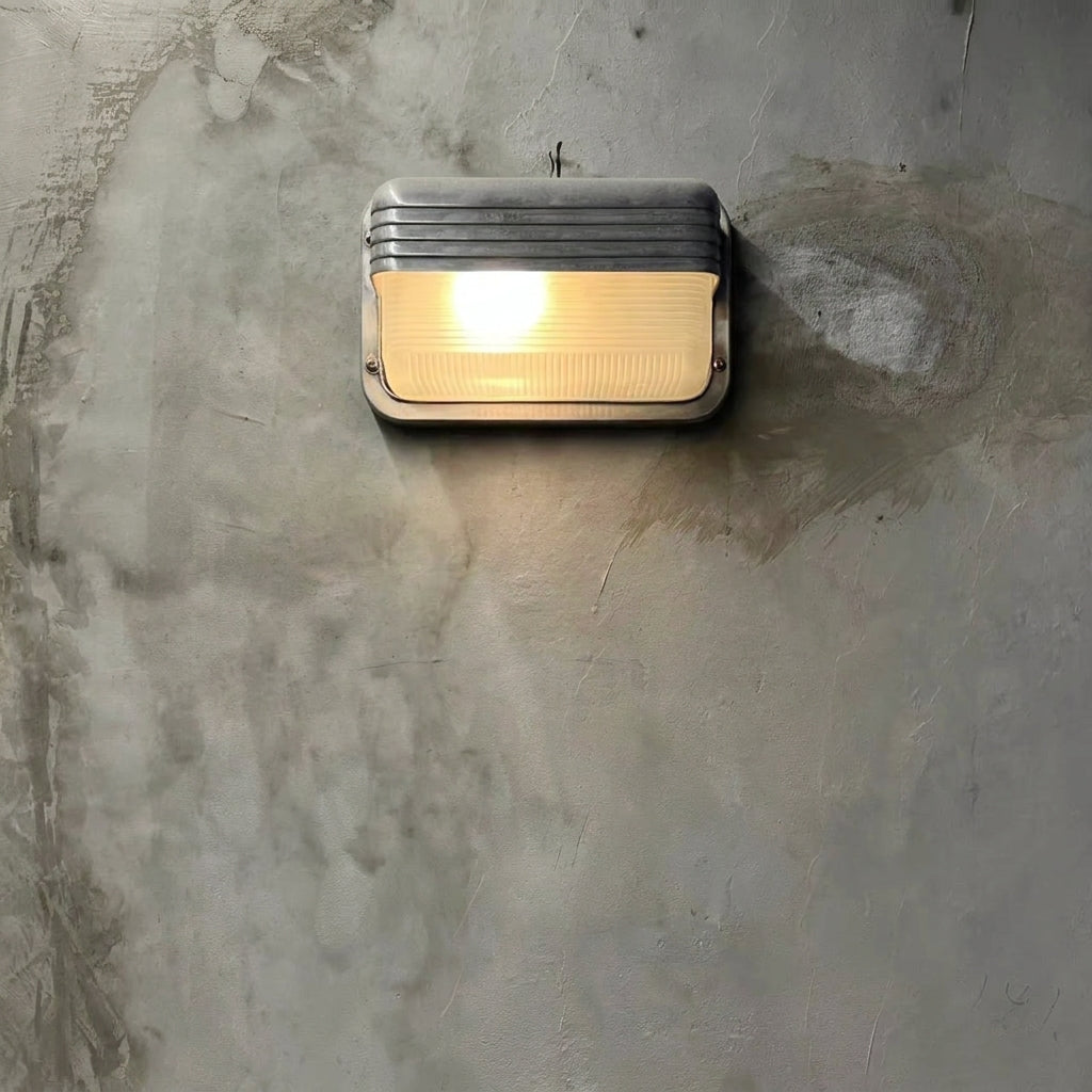 Ostin landscape louvred hood bulkhead wall light lit on a concrete wall