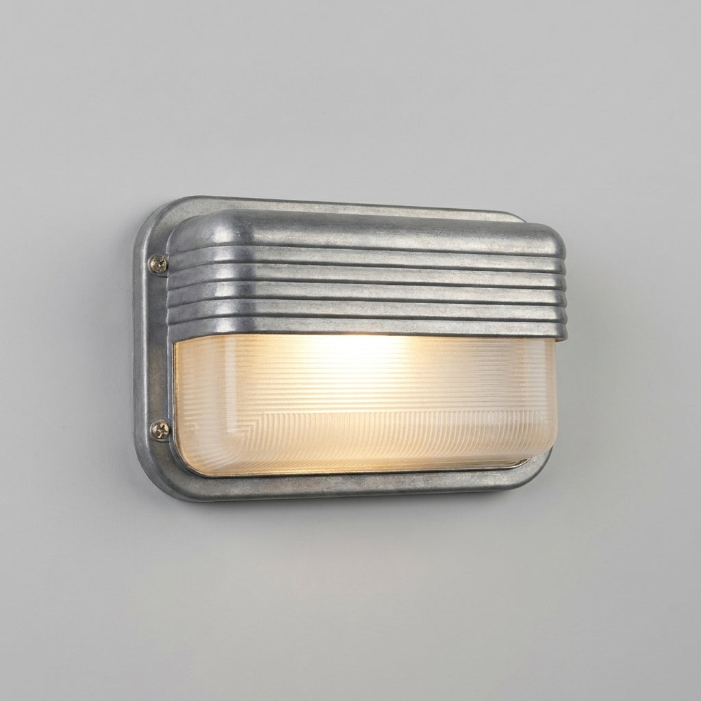 Ostin landscape louvred hood bulkhead wall light lit on a grey wall