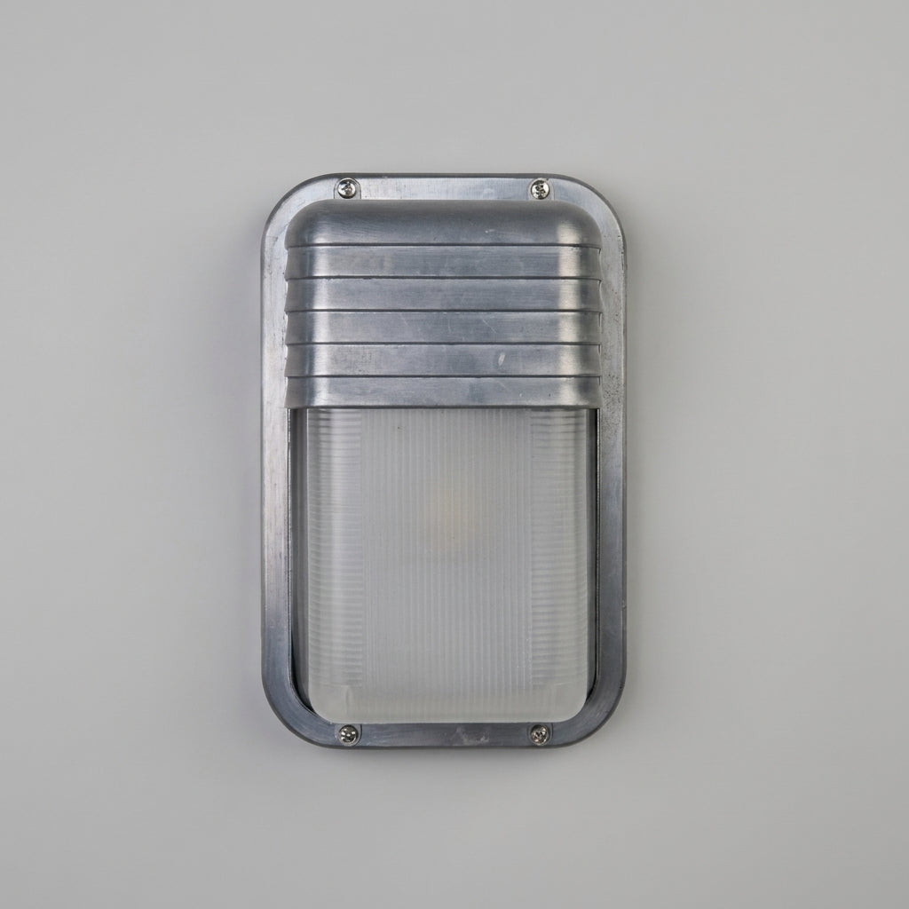 Ostin portrait louvred hood bulkhead wall light unlit on a grey wall