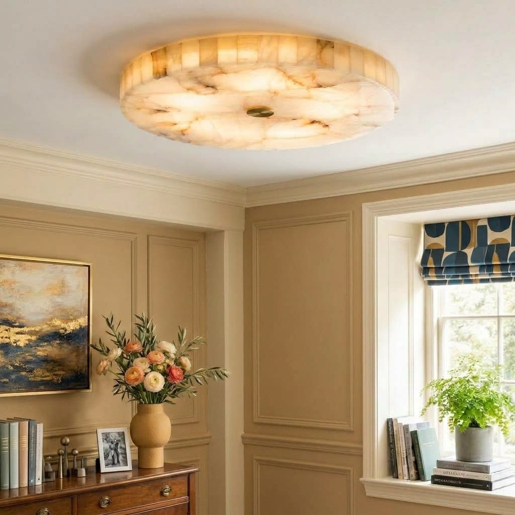 A round flush-mount ceiling light with a marble pattern, installed in a classic room with beige panelled walls, a wooden console table, and a window with a blue patterned valance.