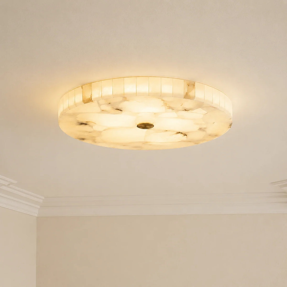 A round flush-mount marble ceiling light fixture with a warm white tones installed on a beige ceiling.