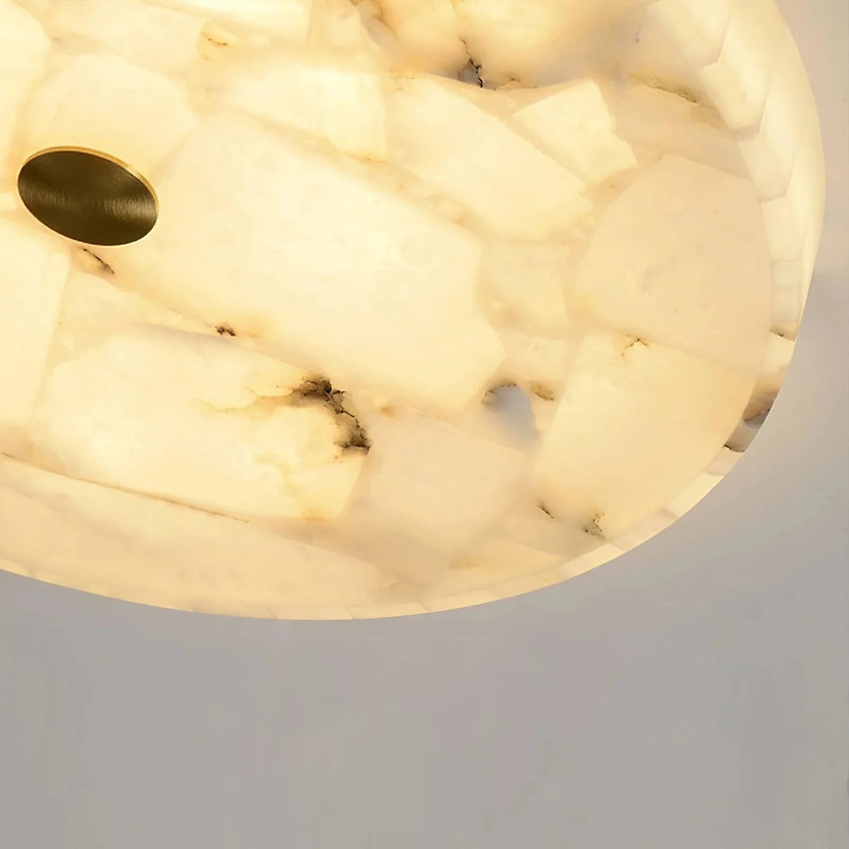 Close-up of a marble ceiling light fixture on a neutral background