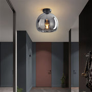 Modern smoke grey retro glass globe flush mount pawo ceiling light illuminating a contemporary entryway