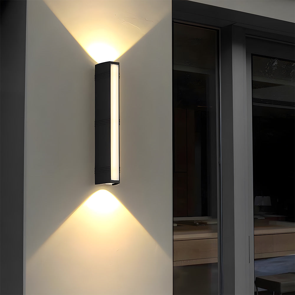 Minimalist black peqi outdoor sconce acting as elegant accent lighting next to a large dark window