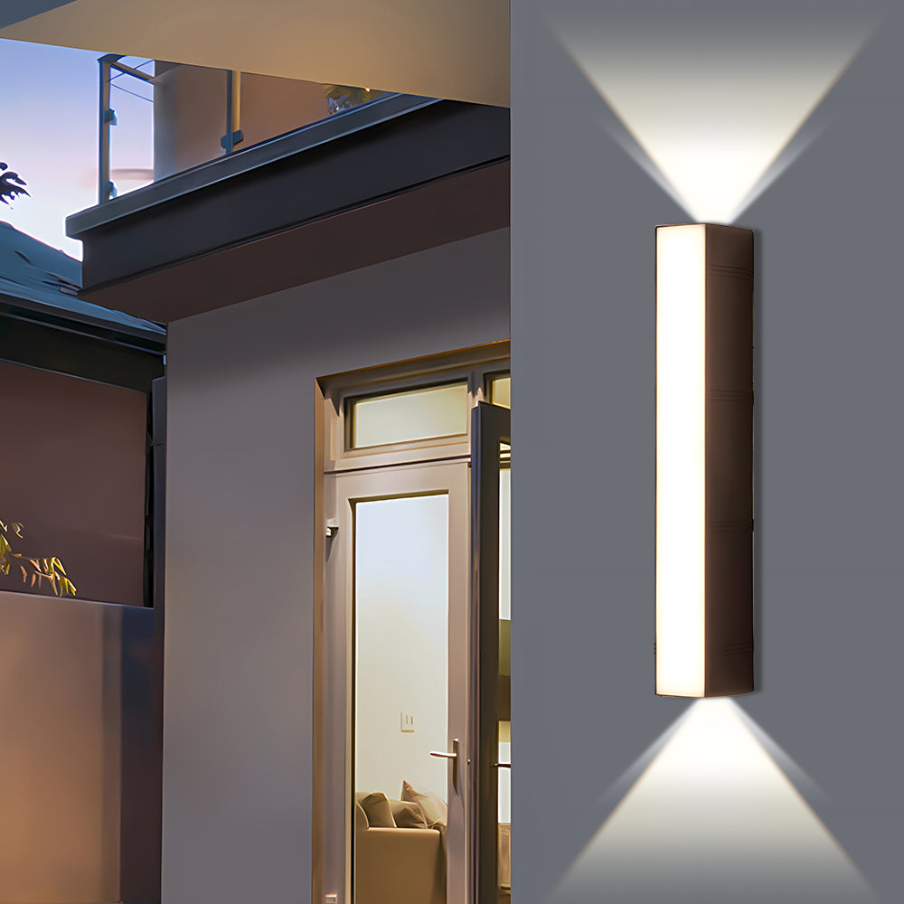 Tall exterior peqi LED sconce illuminating the architectural pillar between two glass patio doors at twilight