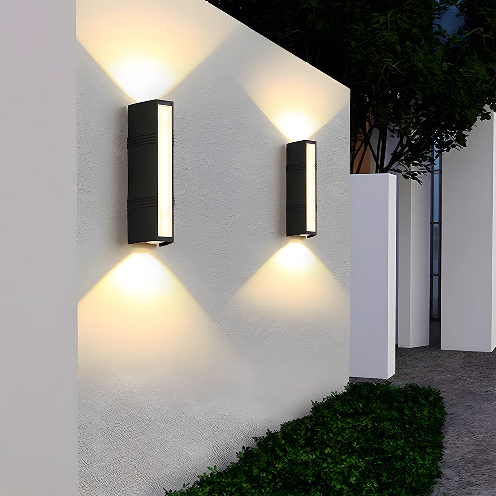 Pair of black linear peqi exterior sconces providing up and down pathway lighting on a modern home