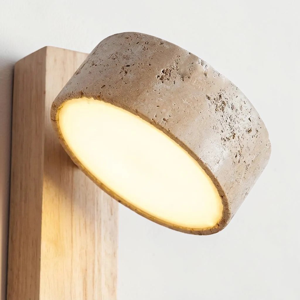 Close-up of Pexni travertine stone shade glowing against the wood backplate