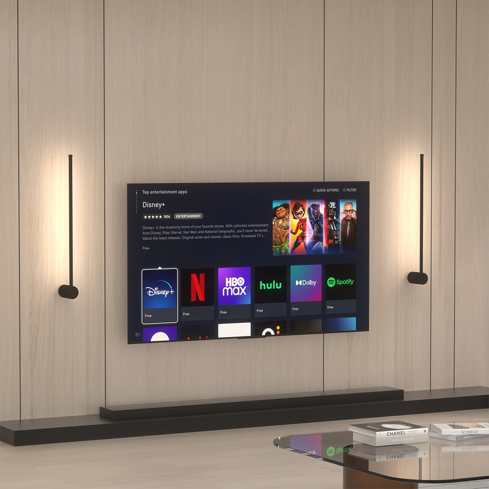 Two modern pila linear LED wall sconces mounted vertically to beautifully frame a living room television