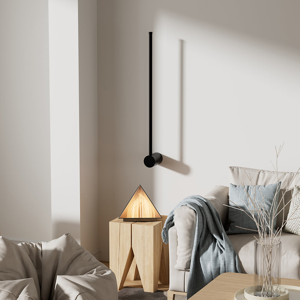 Minimalist pila black linear wall lamp acting as an elegant living room accent sconce in a cosy corner