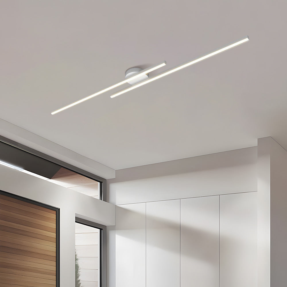 Crisp white staggered linear LED poxu ceiling light glowing warmly in a modern interior