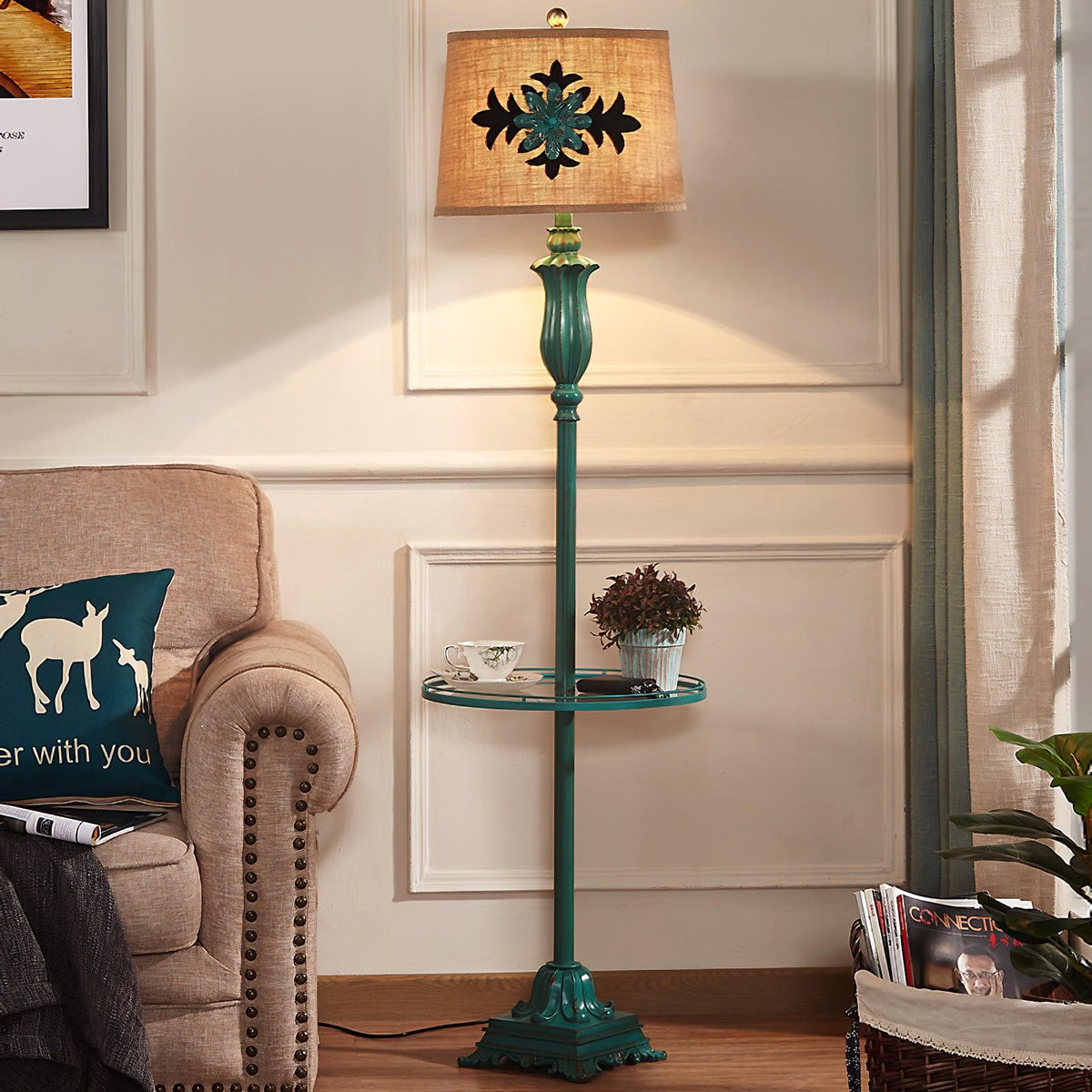 Rustic green puska standing lamp with an integrated table providing warm ambient light next to a classic sofa