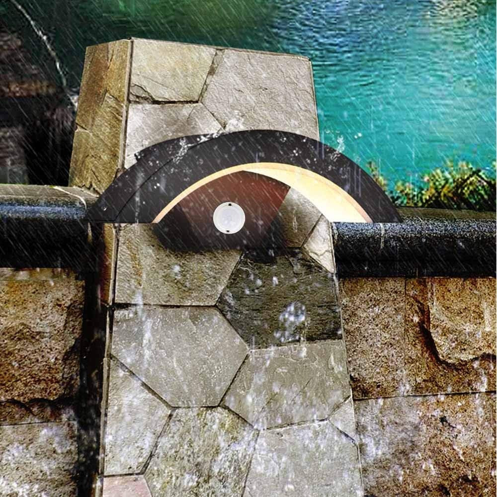 qaxo waterproof arched garden wall light illuminating a decorative outdoor stone wall