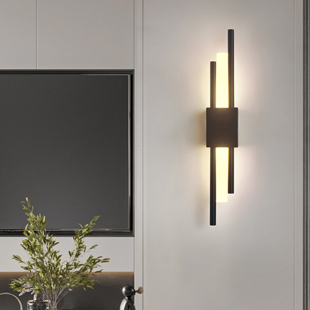 Black linear qytu wall lamp providing elegant accent lighting next to a tv