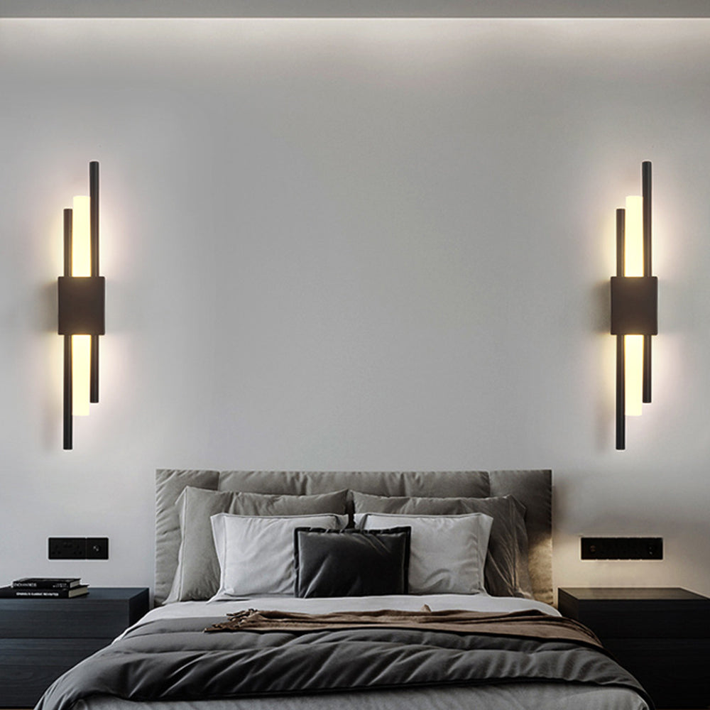 Pair of black staggered LED qytu wall sconces symmetrically framing a bed in a contemporary bedroom