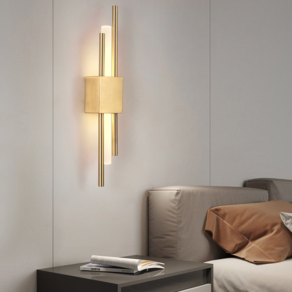 gold qytu staggered LED sconce providing a warm, cosy glow in a modern bedroom