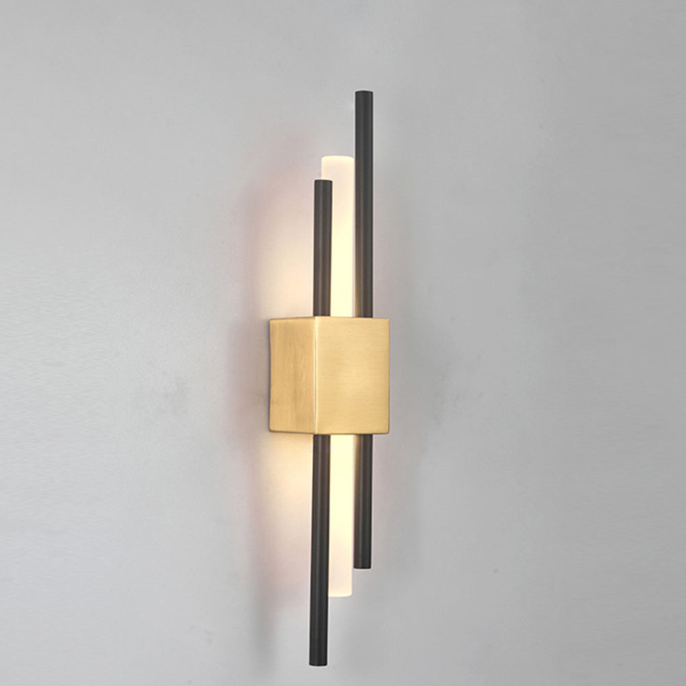 Elegant gold staggered linear LED qytu wall sconce glowing warmly on a plain neutral wall