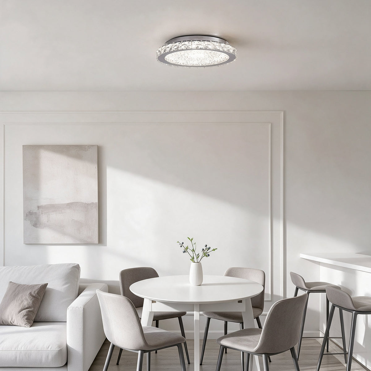 Raden crystal flush mount ceiling light above a dining area with a round table and blue velvet chairs