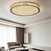 Raden crystal flush mount ceiling light in warm white above a living room with sheer curtains and a cream armchair