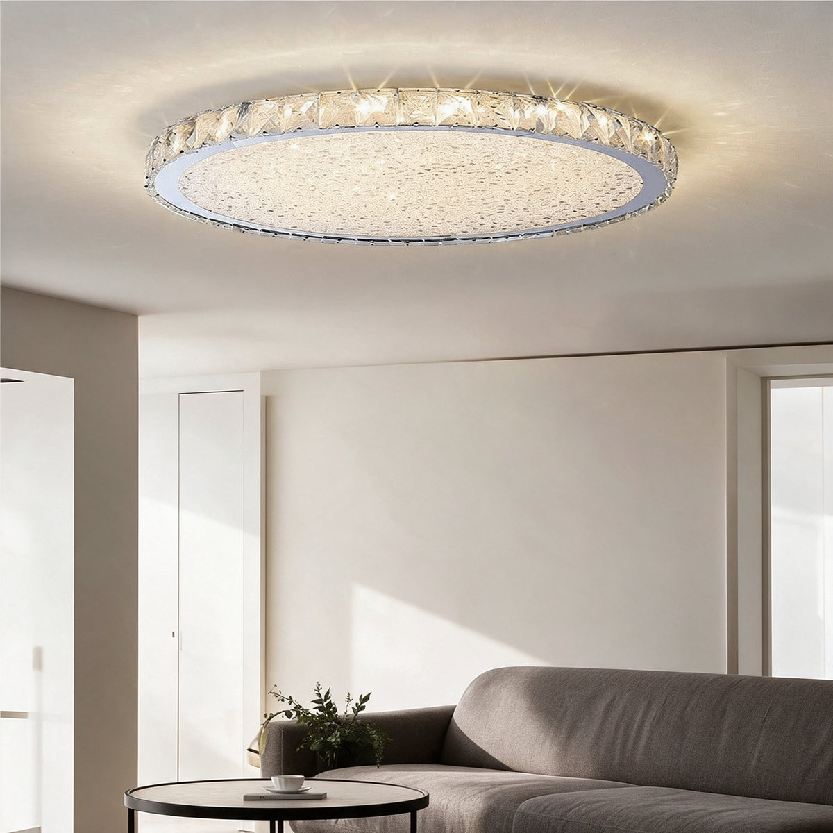Raden crystal flush mount ceiling light in warm white above a living room with a dark accent wall and green velvet sofa