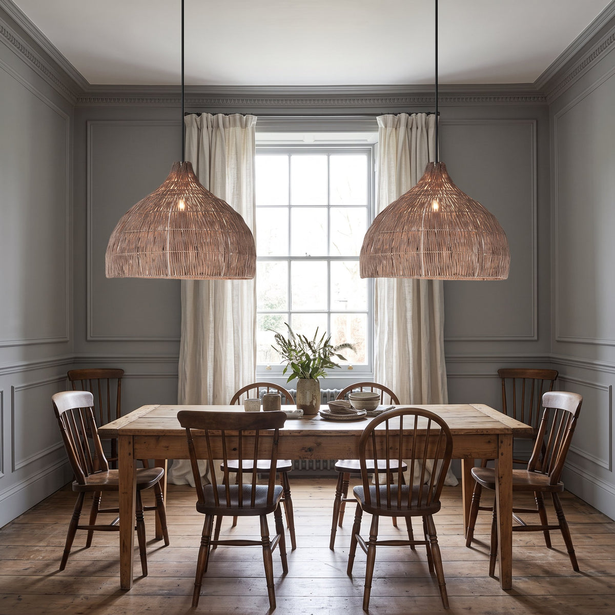 2 Relton rattan pendant lights above a wooden dining table in a grey British dining room