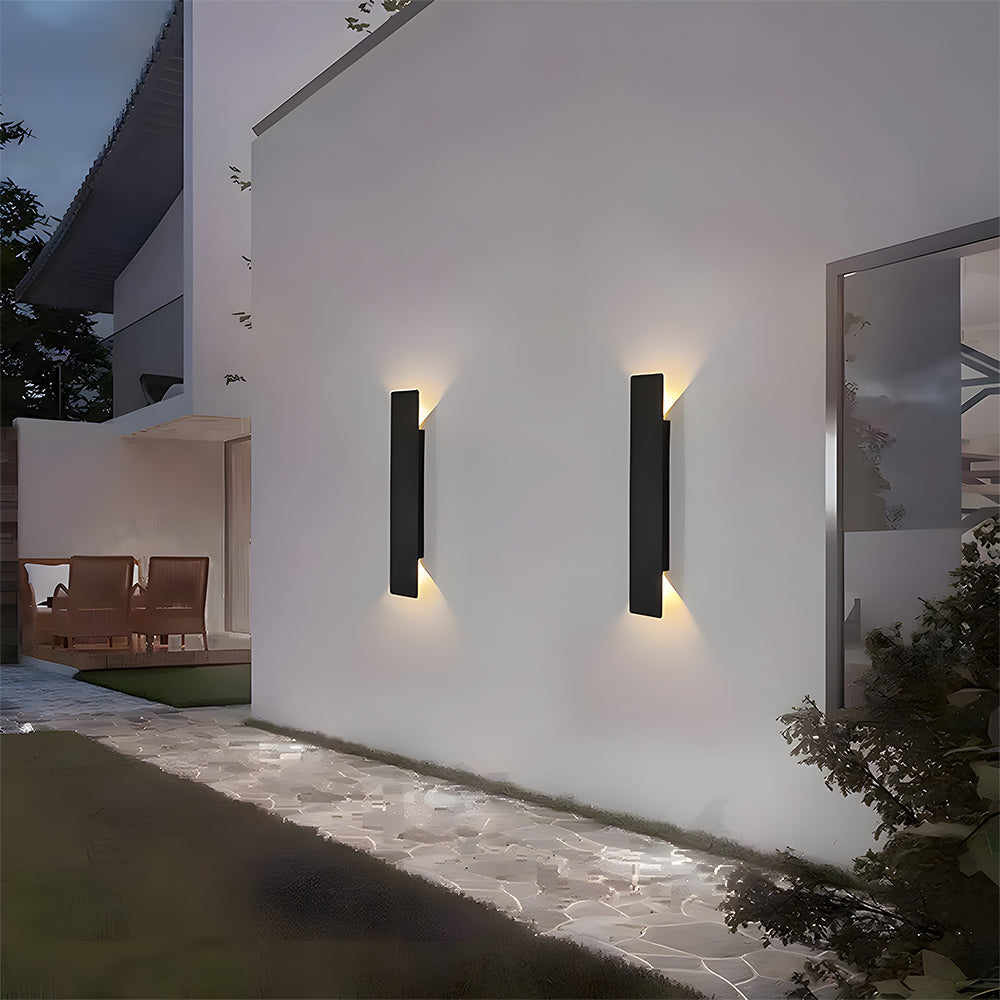 two reta IP65 waterproof black outdoor wall lights illuminating a modern patio area