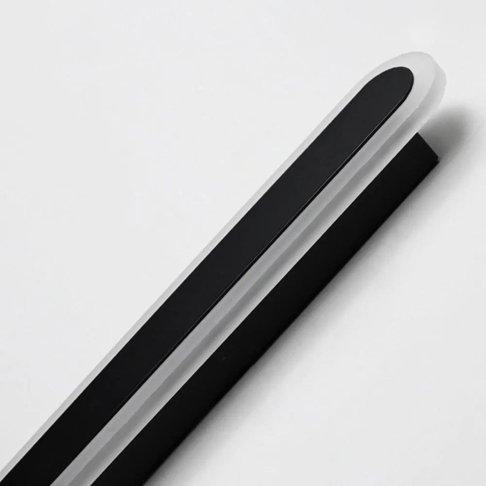 Riqi linear oval outdoor wall light, close-up of the matte black housing and frosted acrylic diffuser edge