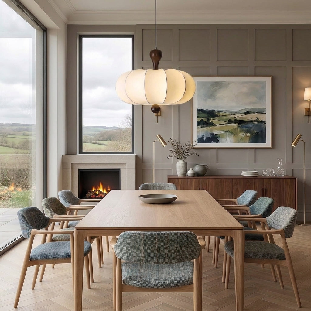 Rizqo pendant light hanging above a wooden dining table in a room with a fireplace