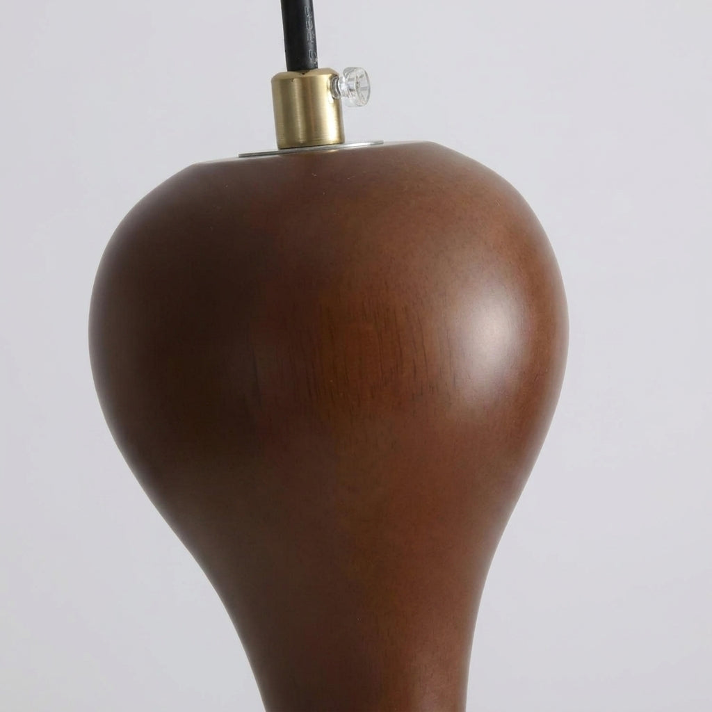 Close-up of Rizqo pendant light's solid walnut wood cap and finial