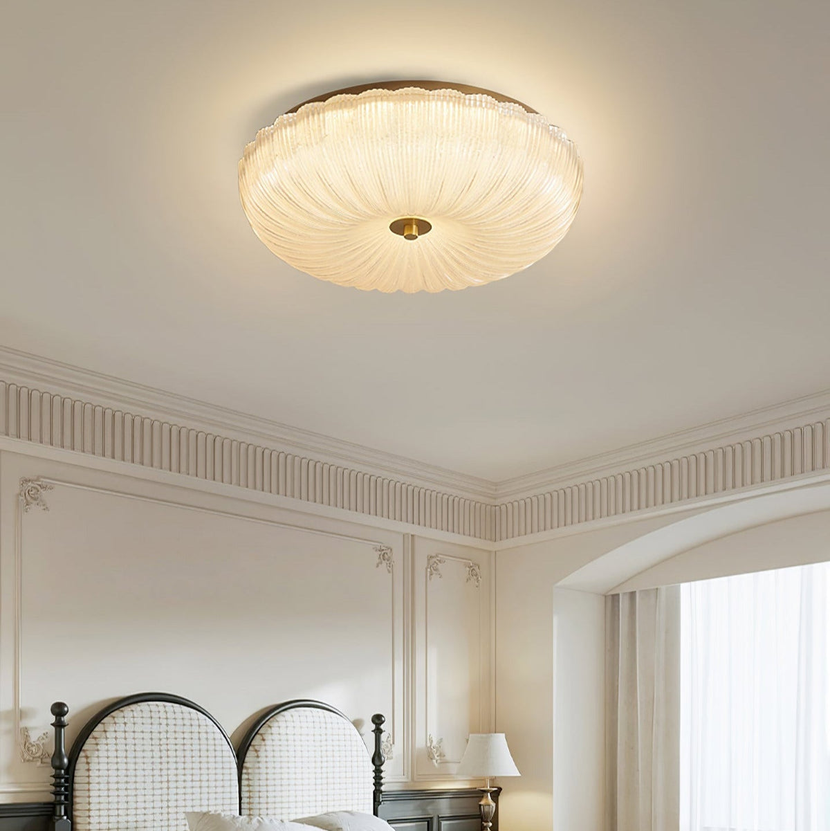 Fluted glass halo rutyl lamp installed in a bedroom with classic wall panelling