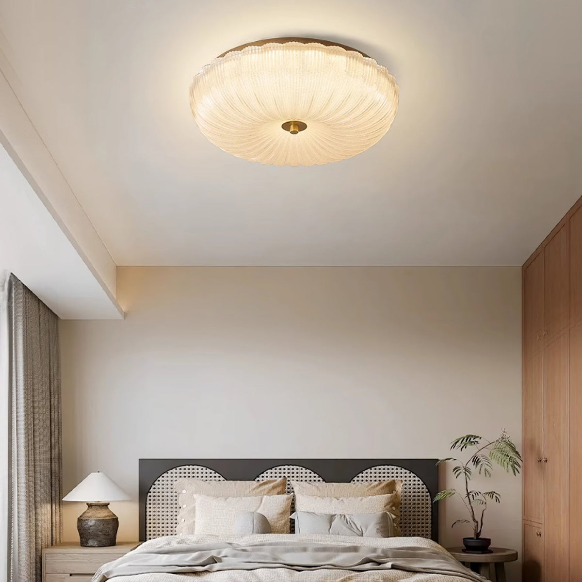 Modern ripple glass flush mount rutyl ceiling light illuminating a minimalist bedroom