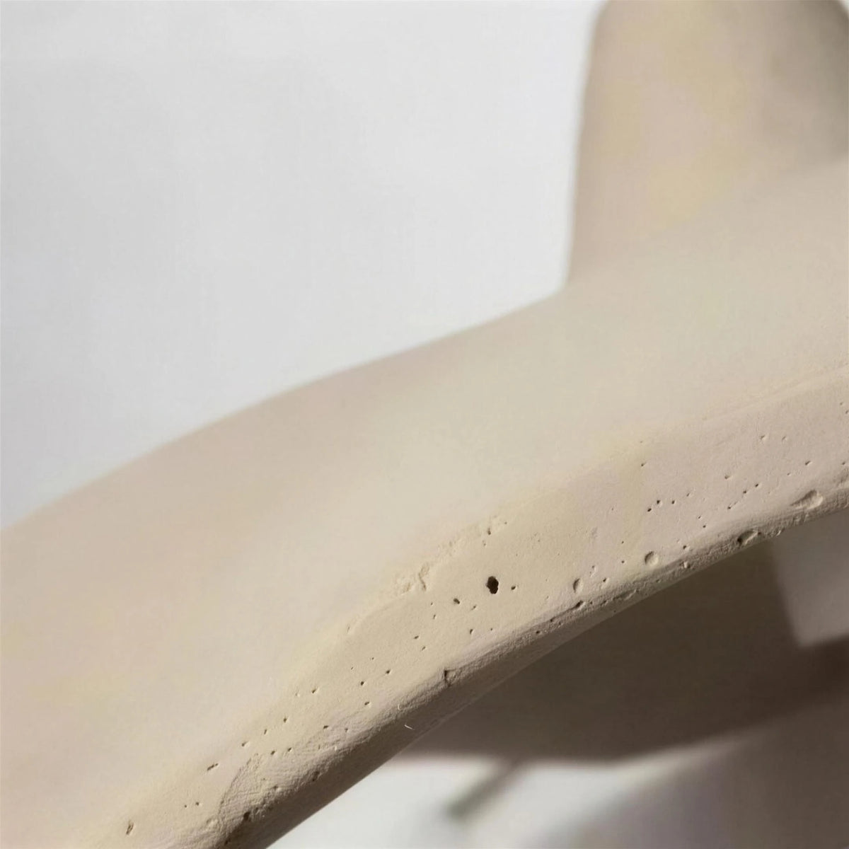 Close-up of the Rylin pendant light's matte concrete-look shade texture