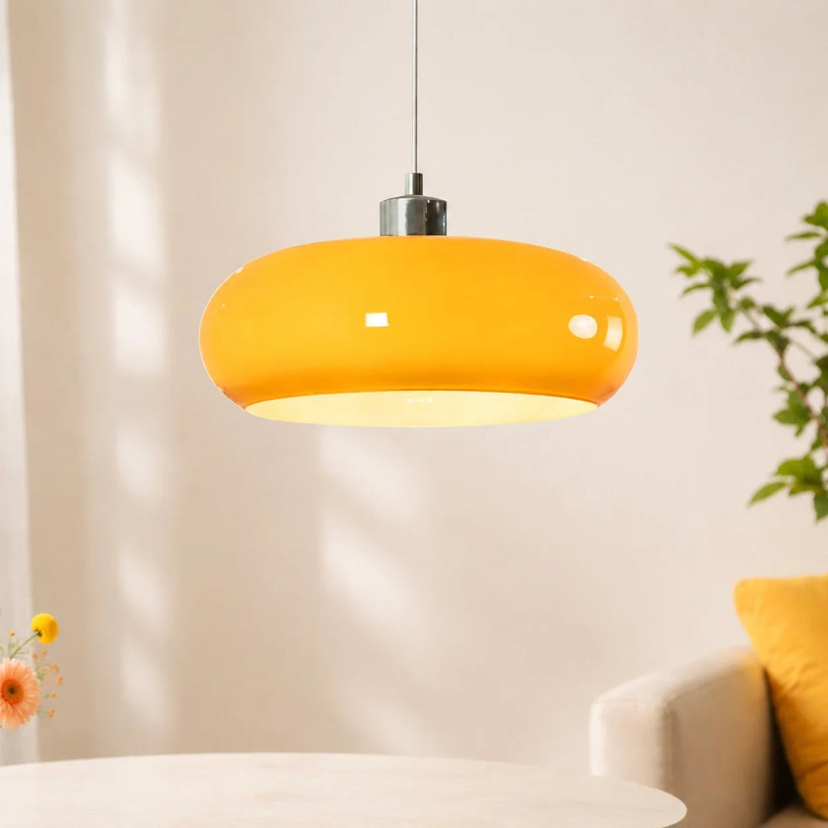 brown glass seqa dome pendant light hanging above a white table in a bright, sunlit modern room
