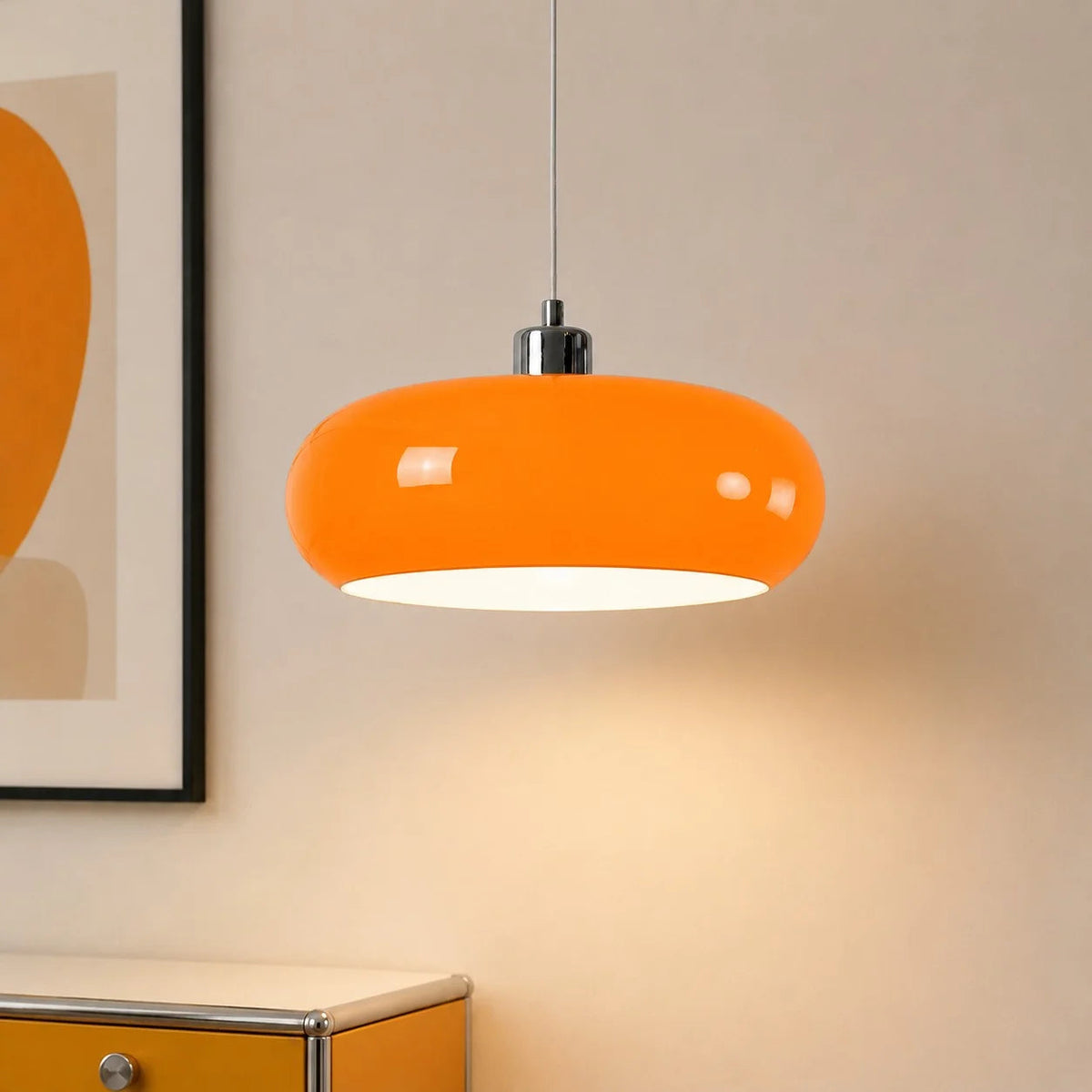 Orange Bauhaus seqa glass dome pendant light illuminating a yellow cabinet and minimalist artwork